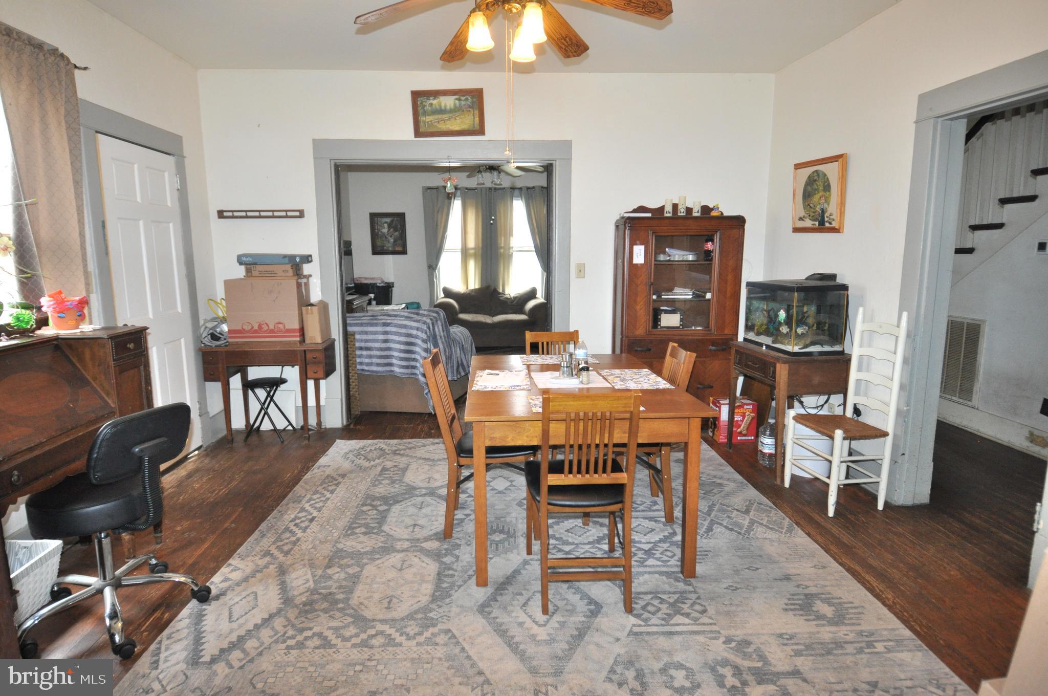 105 Front Street Pocomoke City, MD 21851 - Photo 9 of 50 a dining room with wooden floor and a chandelier