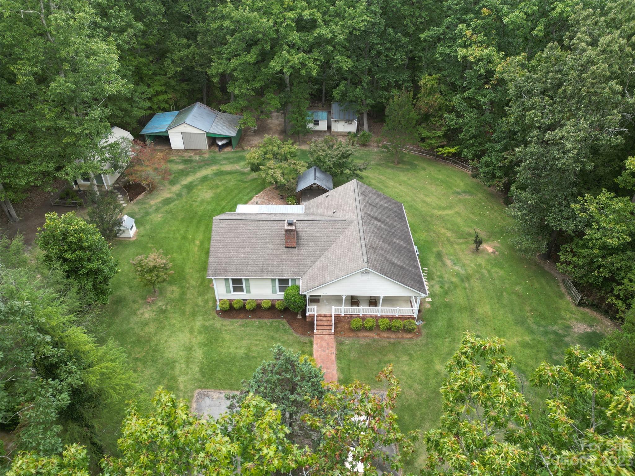 256 Georgewoods Drive Dallas, NC 28034 - Photo 1 of 45 an aerial view of a house with swimming pool and garden