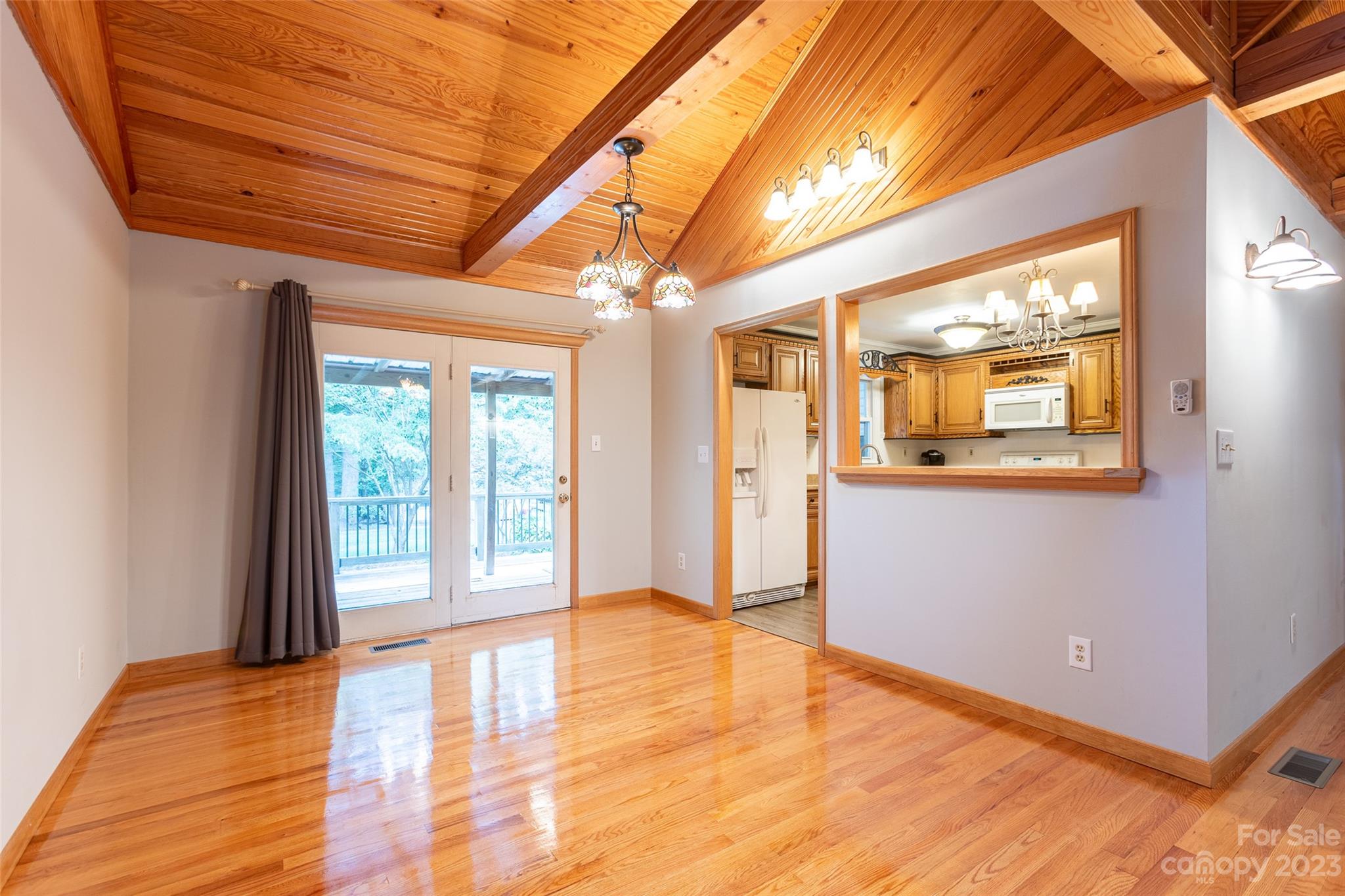 256 Georgewoods Drive Dallas, NC 28034 - Photo 12 of 45 a view of an empty room with wooden floor and a window