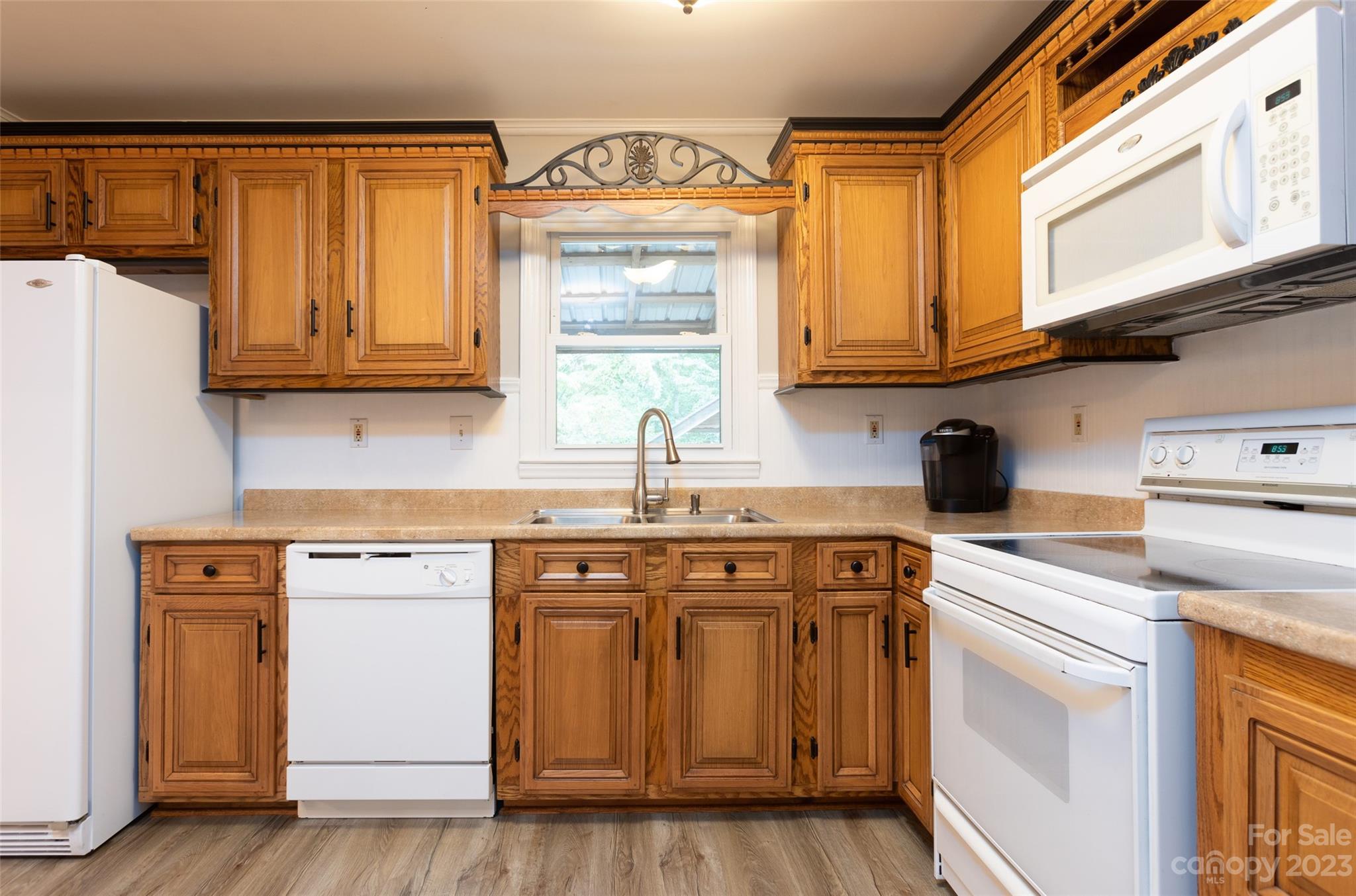 256 Georgewoods Drive Dallas, NC 28034 - Photo 14 of 45 a kitchen with stainless steel appliances granite countertop a sink and cabinets with wooden floor