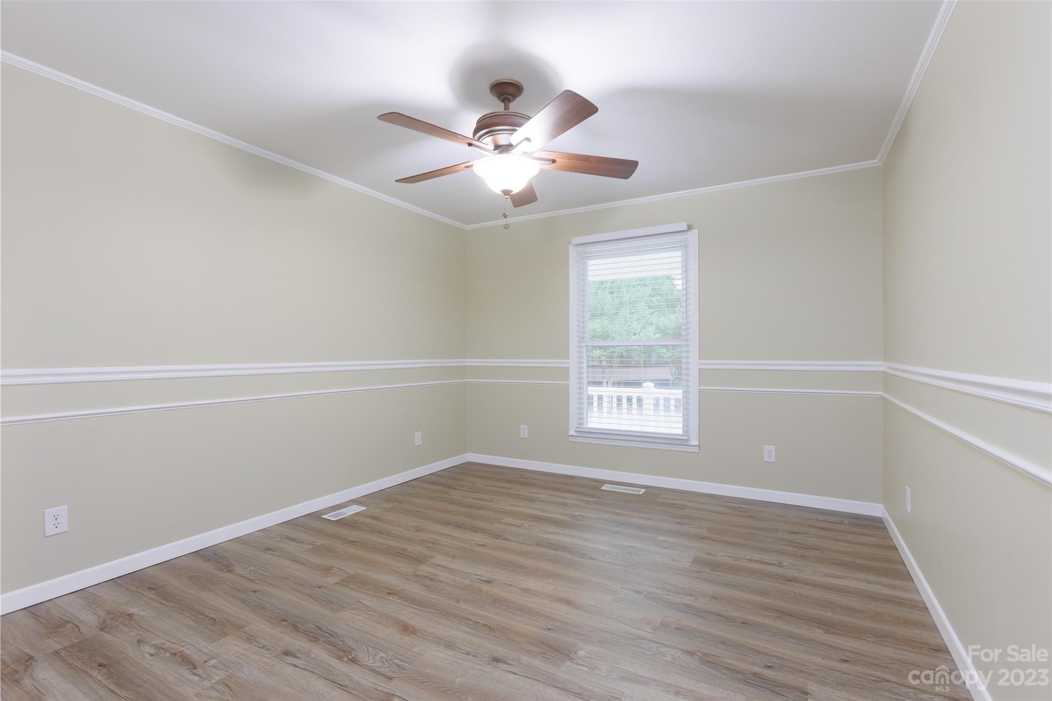 256 Georgewoods Drive Dallas, NC 28034 - Photo 25 of 45 a view of an empty room with wooden floor and a window