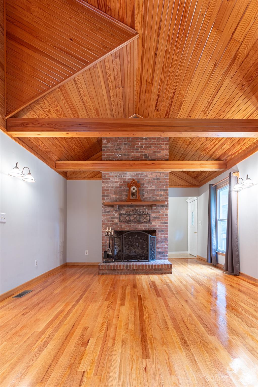 256 Georgewoods Drive Dallas, NC 28034 - Photo 6 of 45 a view of empty room with wooden floor and fireplace