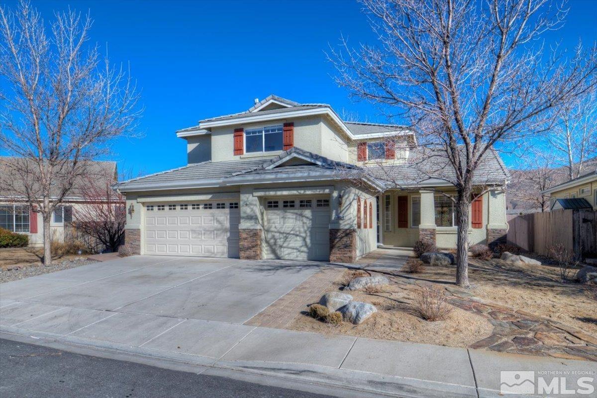 10016 Cascade Falls Drive Reno, NV 89521 - Photo 1 of 40 a front view of a house with a yard