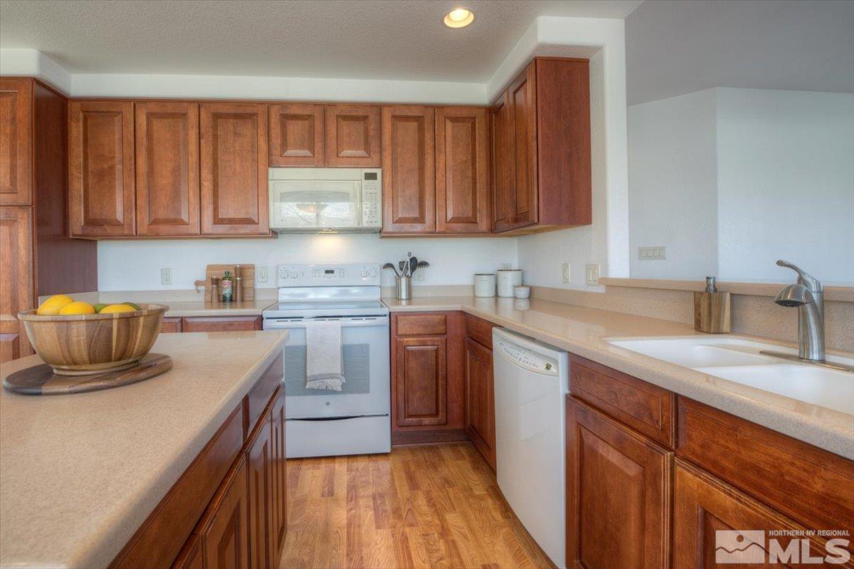 10016 Cascade Falls Drive Reno, NV 89521 - Photo 12 of 40 a kitchen with a sink stove and cabinets