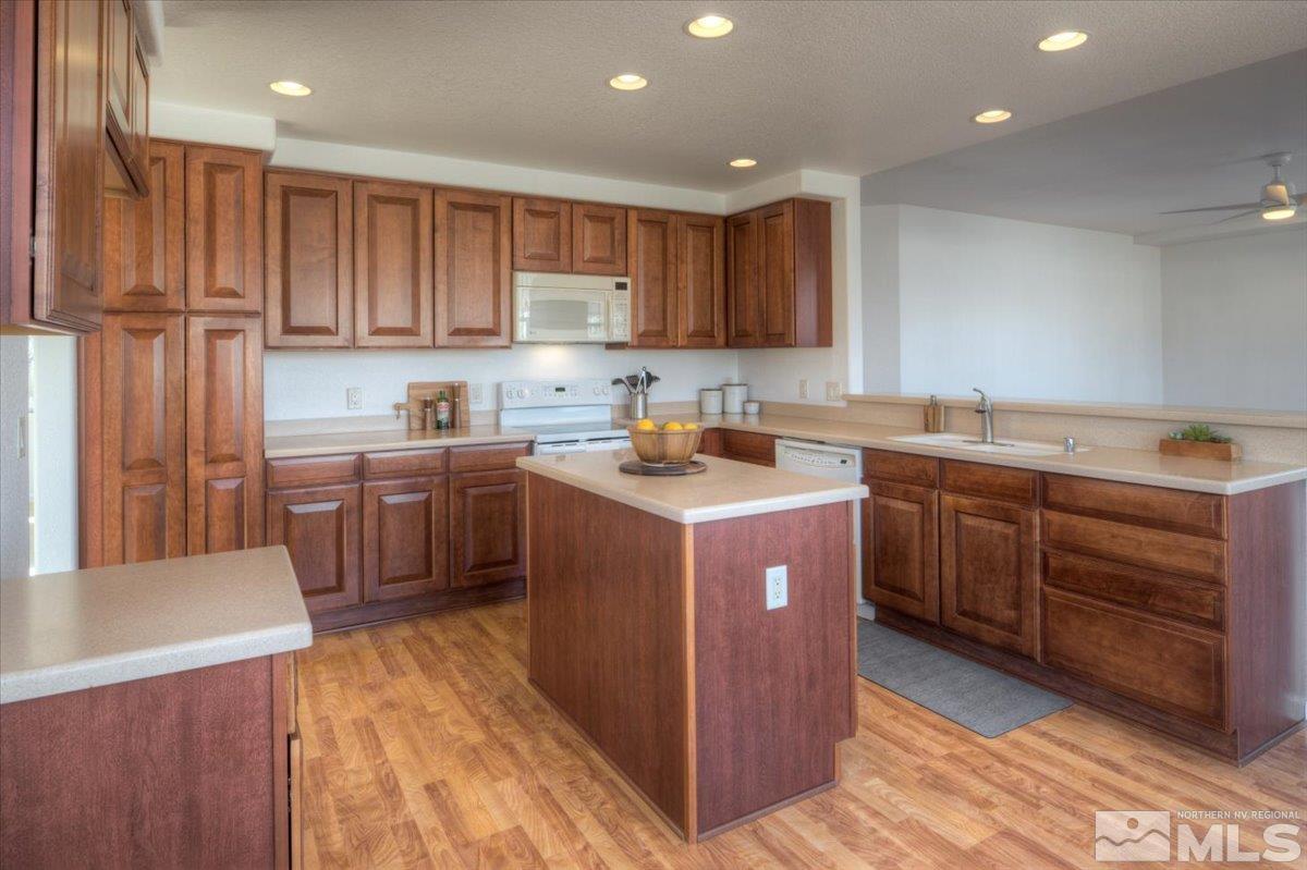 10016 Cascade Falls Drive Reno, NV 89521 - Photo 13 of 40 a kitchen with a sink a stove and cabinets