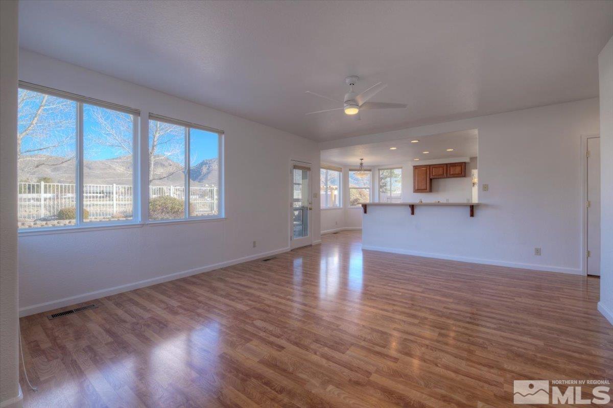 10016 Cascade Falls Drive Reno, NV 89521 - Photo 17 of 40 a view of empty room with wooden floor and windows