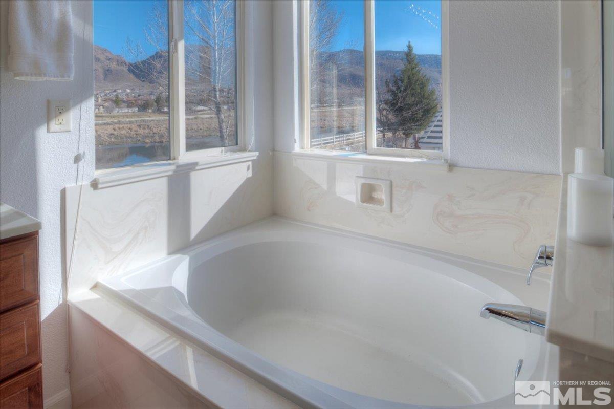 10016 Cascade Falls Drive Reno, NV 89521 - Photo 23 of 40 a bathroom with a bathtub and window