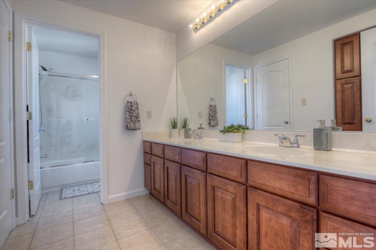 10016 Cascade Falls Drive Reno, NV 89521 - Photo 29 of 40 a bathroom with a tub sink and mirror