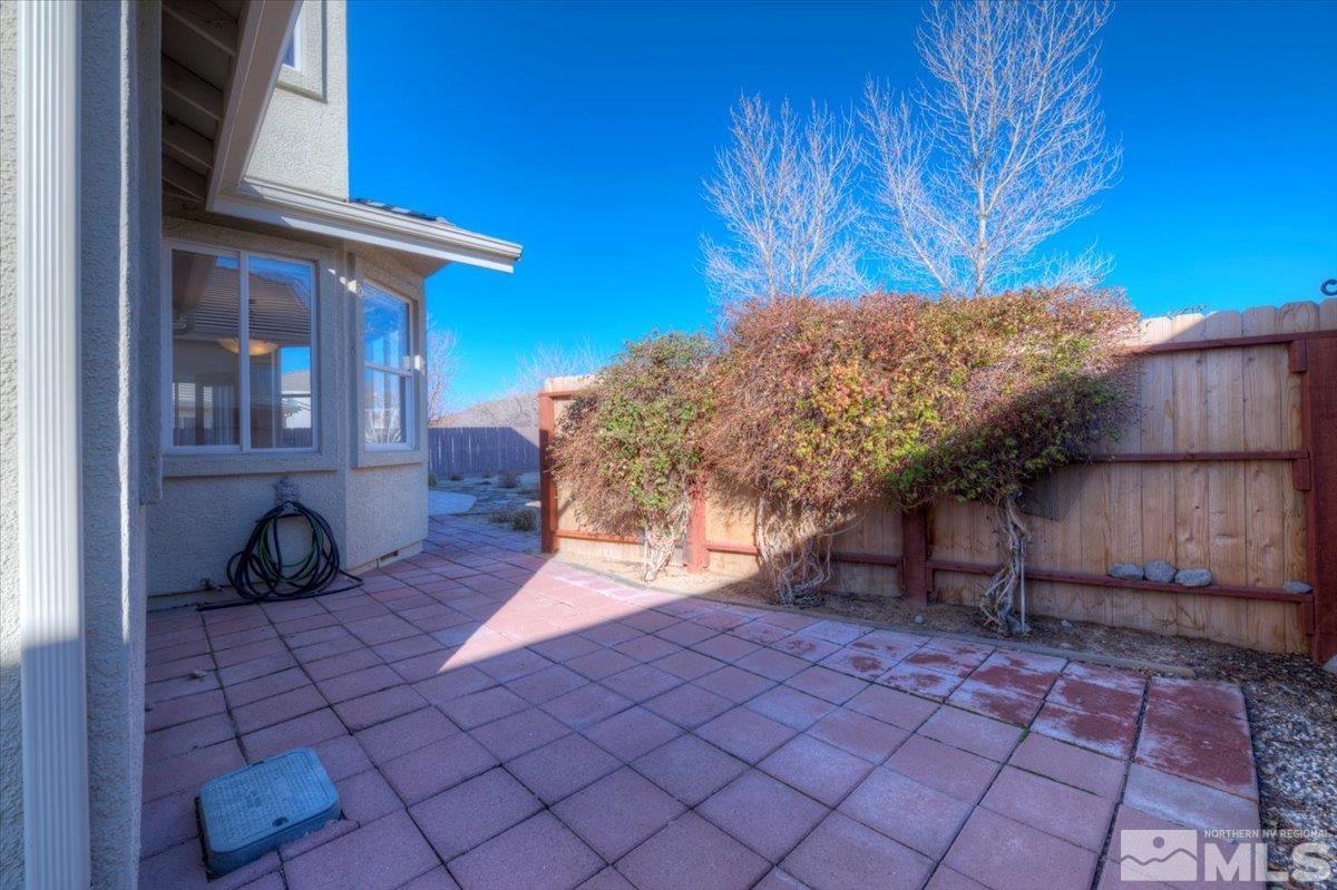 10016 Cascade Falls Drive Reno, NV 89521 - Photo 37 of 40 a view of a backyard with table and chairs and potted plants