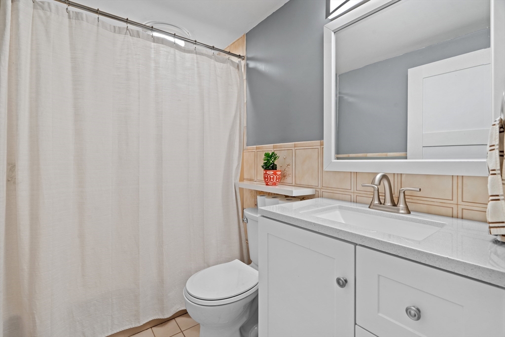 61 Broad Street Walpole, MA 02081 - Photo 15 of 37 a bathroom with a granite countertop sink and a toilet