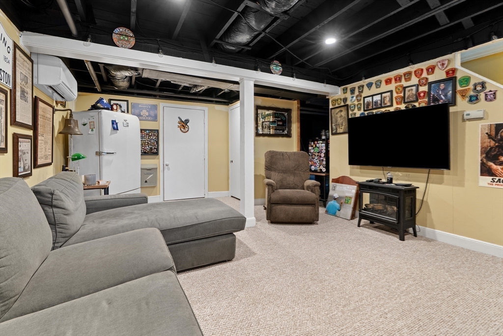 61 Broad Street Walpole, MA 02081 - Photo 20 of 37 a living room with furniture and a flat screen tv