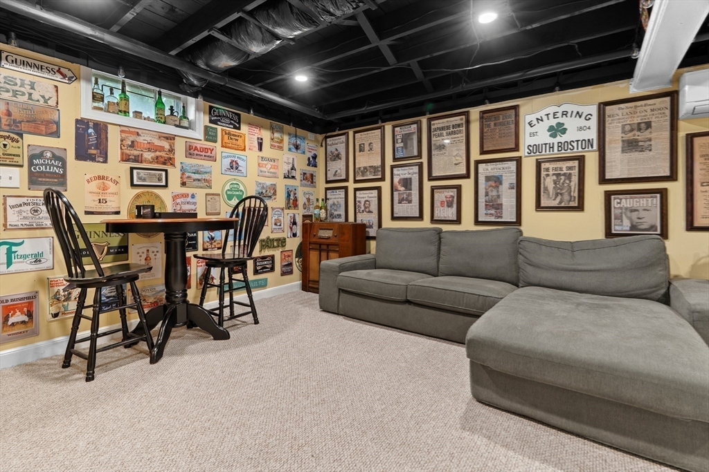 61 Broad Street Walpole, MA 02081 - Photo 21 of 37 a living room with furniture a chandelier and a wooden floor