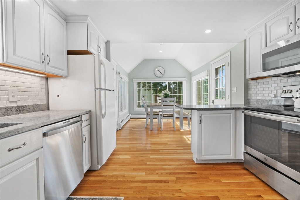 61 Broad Street Walpole, MA 02081 - Photo 6 of 37 a kitchen with stainless steel appliances granite countertop a stove a sink and a refrigerator