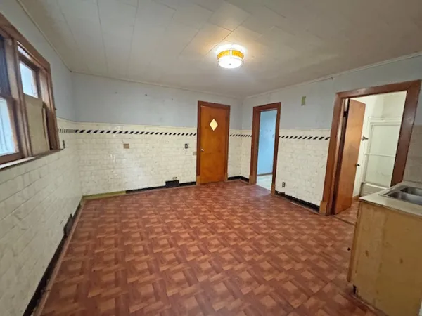 a view of a livingroom with wooden floor and staircase