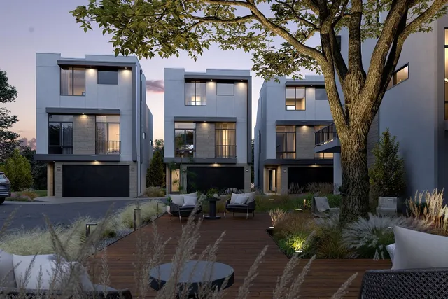 a front view of a house with yard and trees