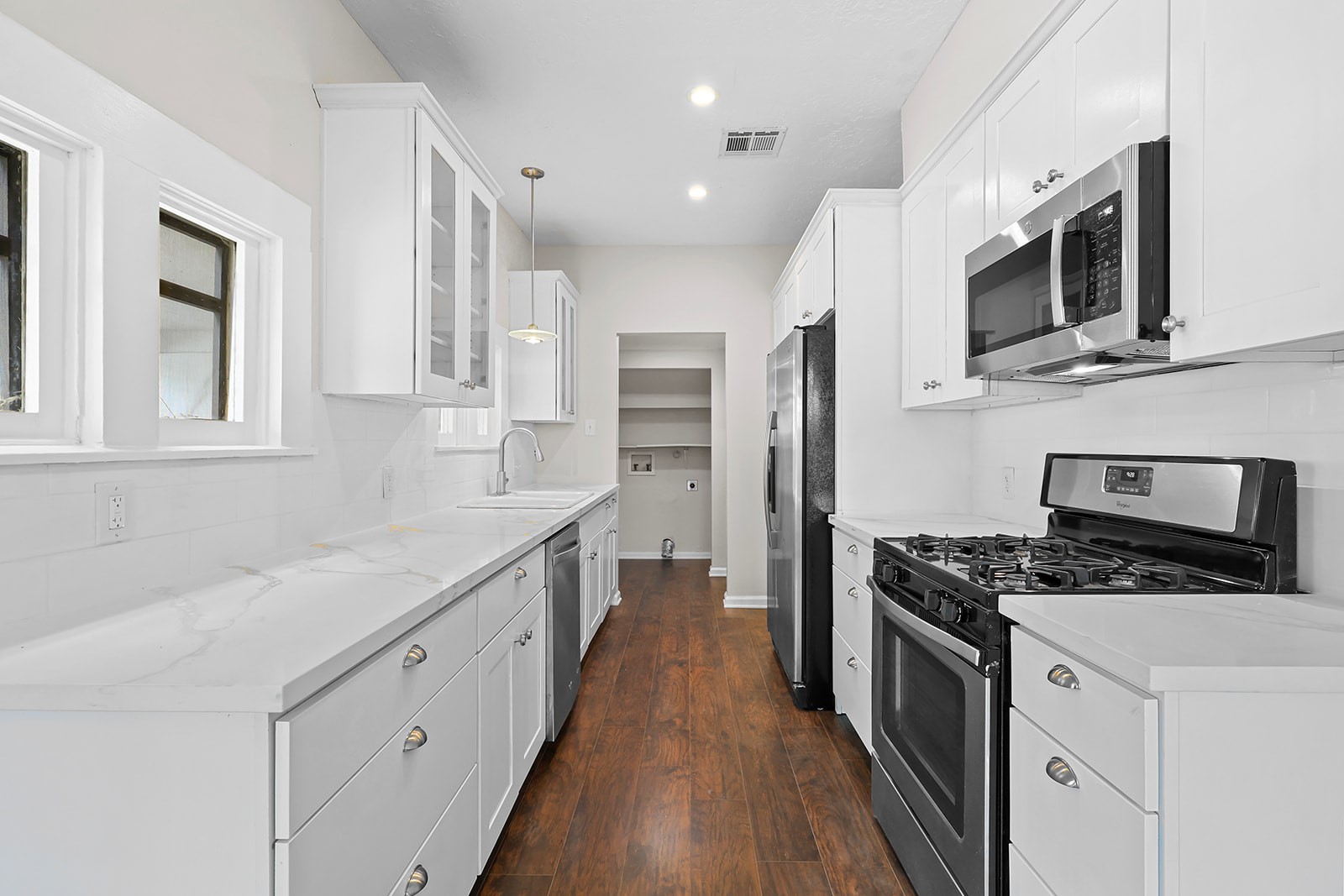5401 North Capitol Street Houston, TX 77011 - Photo 13 of 34 a kitchen with stainless steel appliances a stove microwave and refrigerator