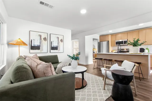 a living room with furniture and a wooden floor