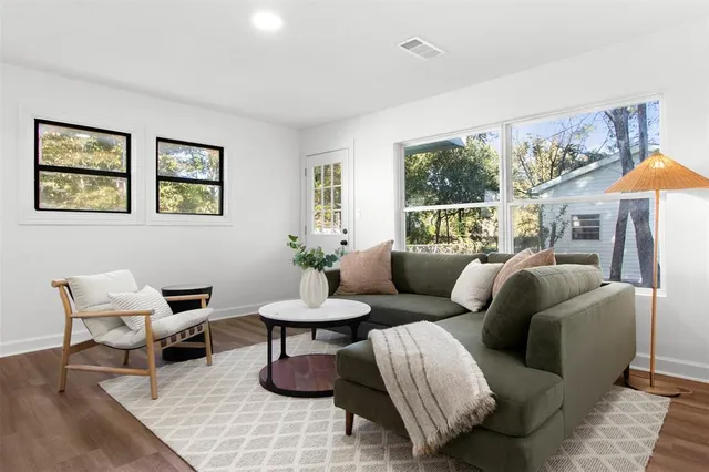 a spacious bedroom with a bed and glass window