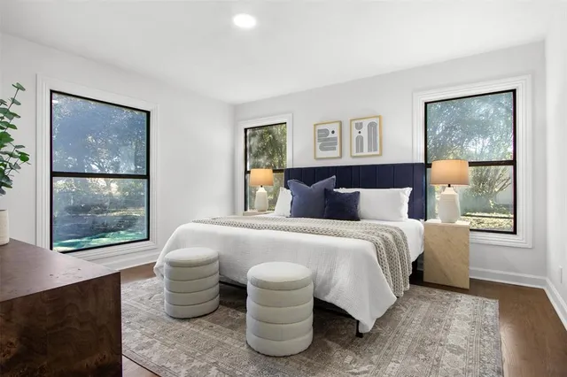 a bedroom with a large bed and a potted plant