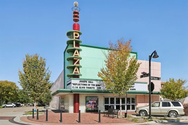 a view of a tall building in the middle of a yard