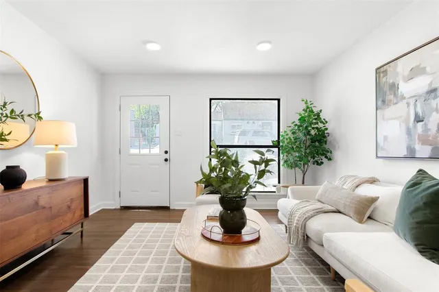a living room with furniture and a potted plant