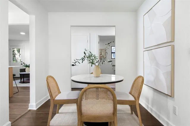 a dining room with furniture and wooden floor