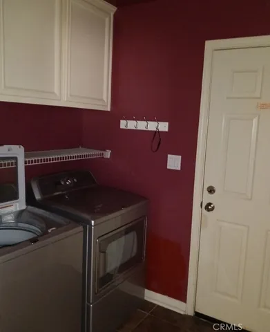 a kitchen with a refrigerator and cabinets