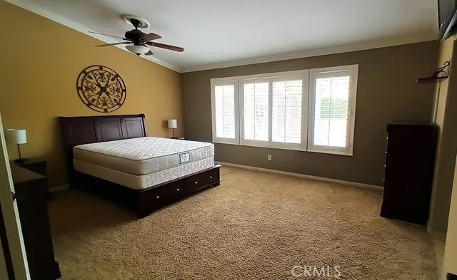 a spacious bedroom with a bed and a window