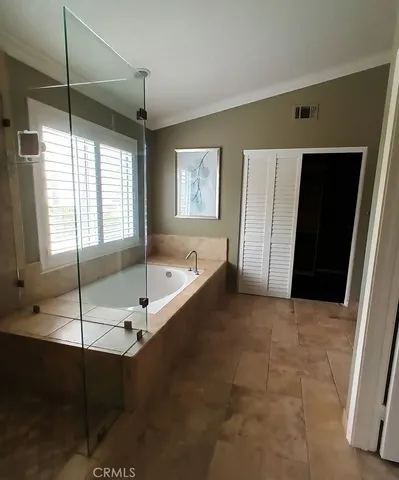 a bathroom with a tub and a shower