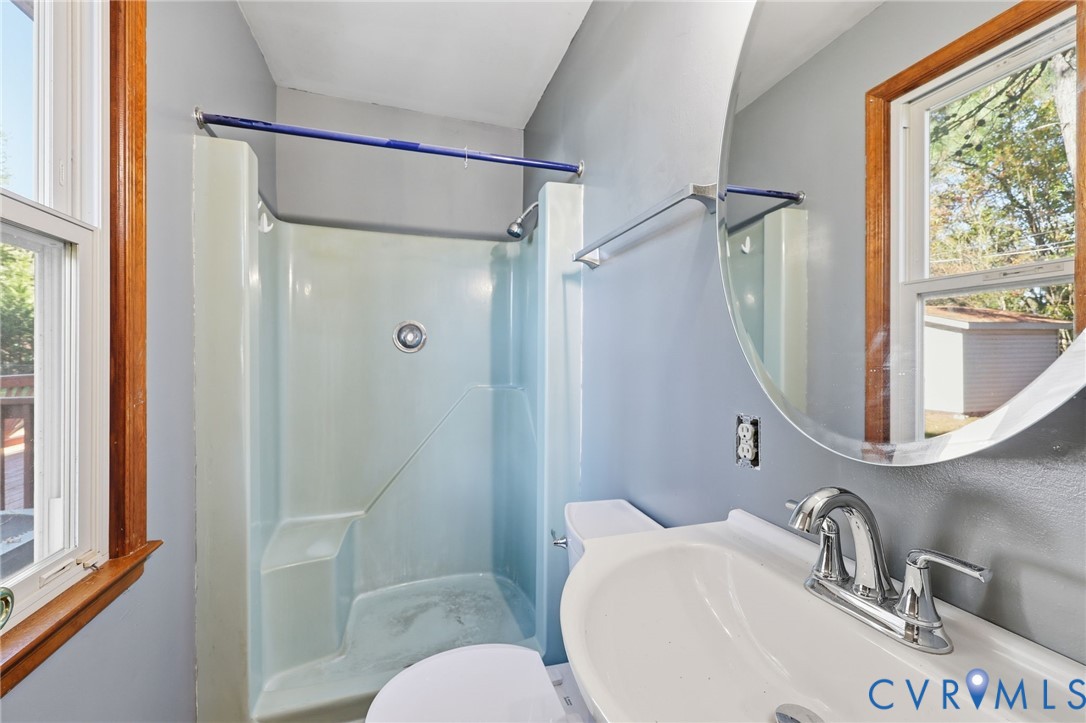 2521 Fort Lee Road Petersburg, VA 23805 - Photo 11 of 27 a bathroom with a sink mirror toilet and shower