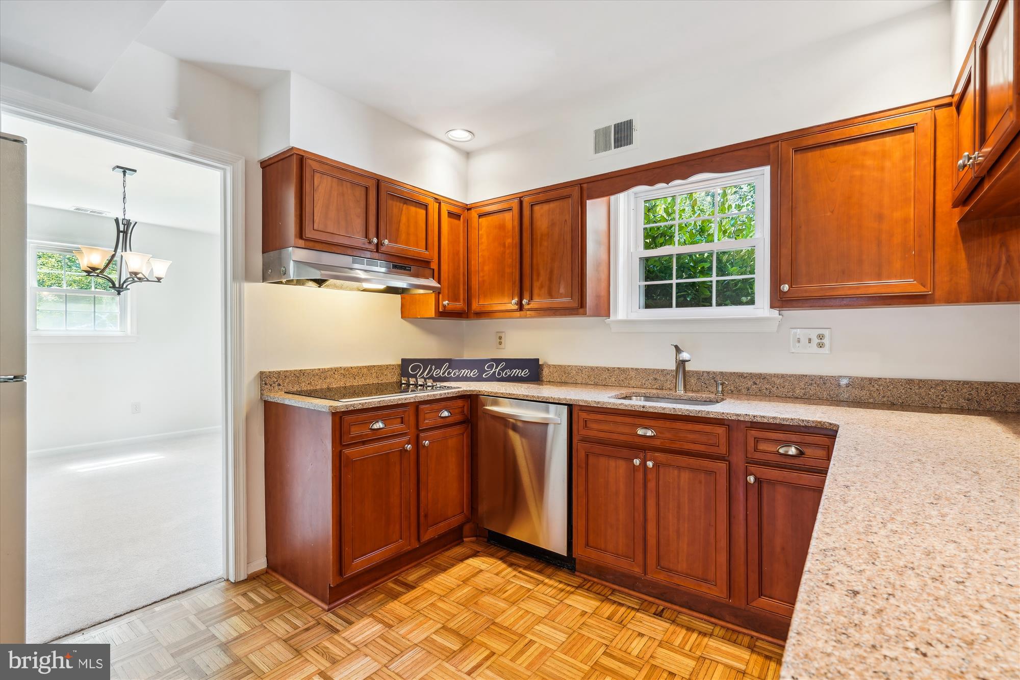 12109 Stirrup Road Reston, VA 20191 - Photo 13 of 52 a kitchen with stainless steel appliances granite countertop a sink stove and refrigerator