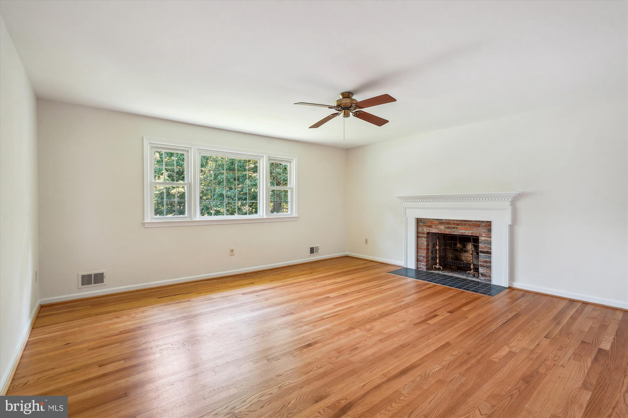 12109 Stirrup Road Reston, VA 20191 - Photo 22 of 52 a view of empty room with a fireplace and wooden floor