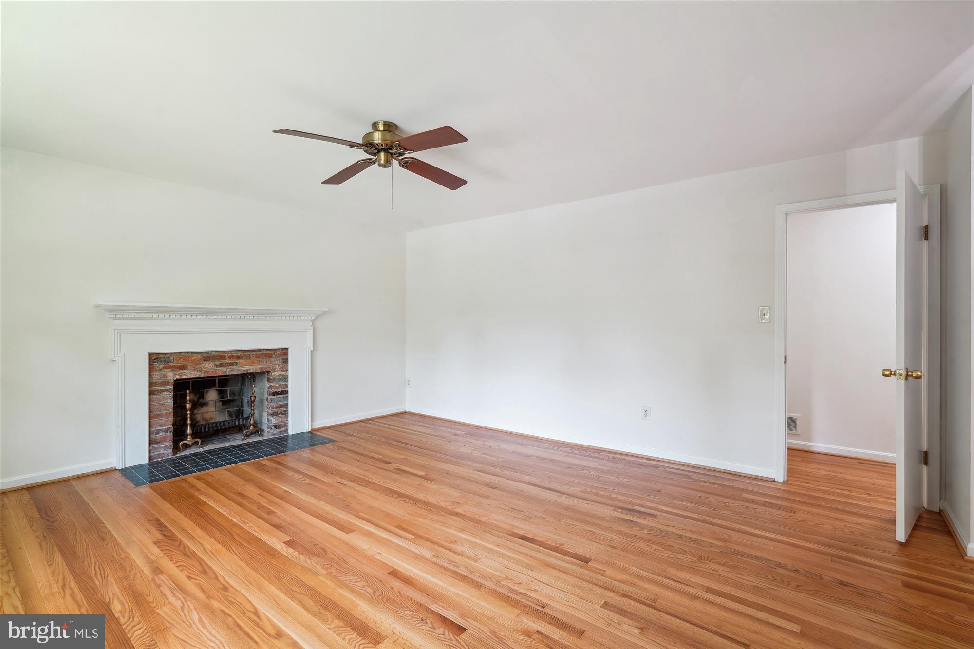 12109 Stirrup Road Reston, VA 20191 - Photo 23 of 52 a view of empty room with wooden floor and fireplace