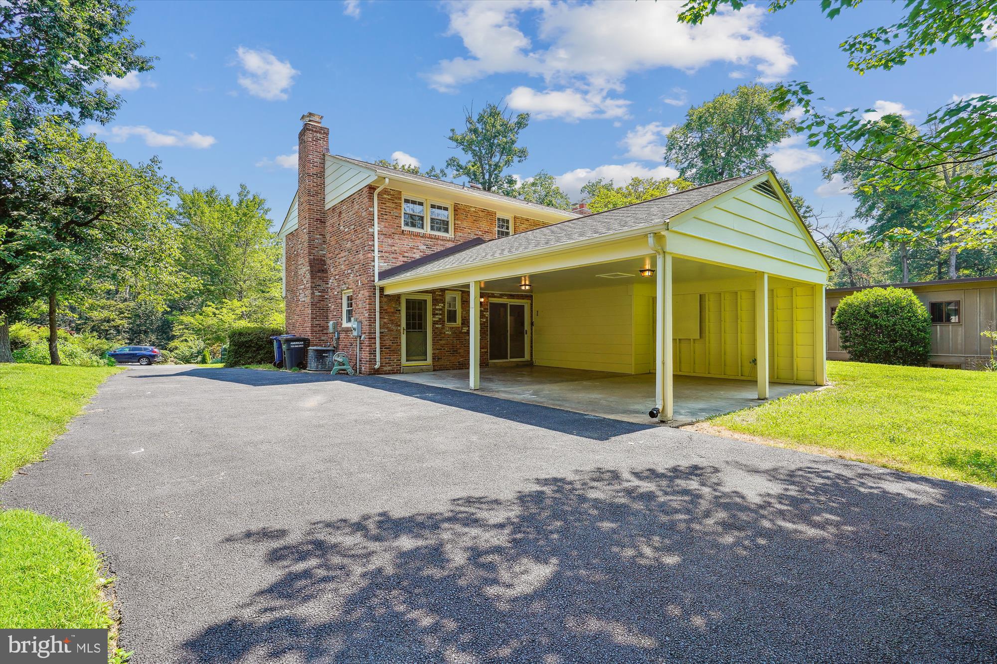 12109 Stirrup Road Reston, VA 20191 - Photo 5 of 52 a front view of a house with a yard and garage