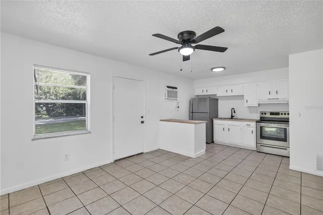 a kitchen with white cabinets and white appliances