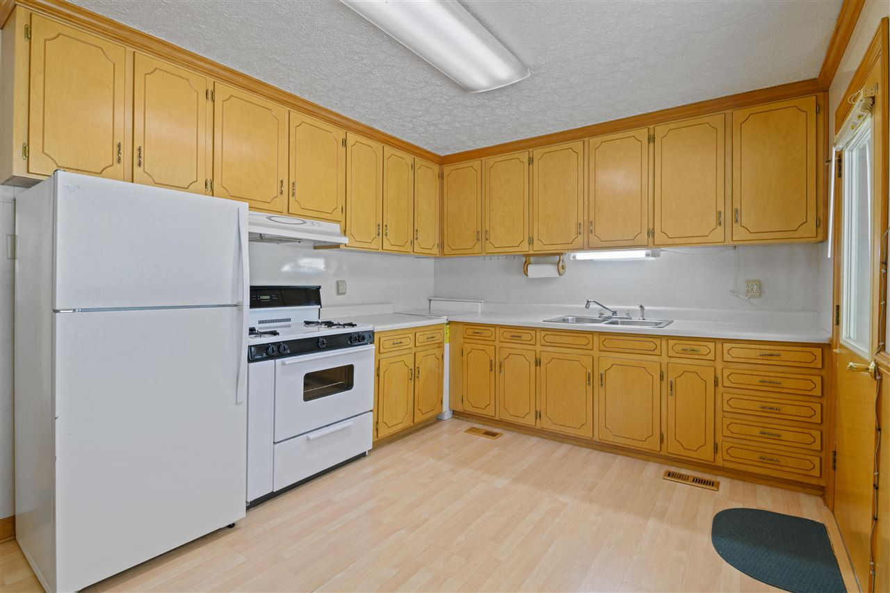 1421 Kelly Road Garner, NC 27529 - Photo 18 of 24 The kitchen was remodeled in the late 70's, it has tall cabinetry that is real wood! Worth saving if another remodel in the the future! Kitchen