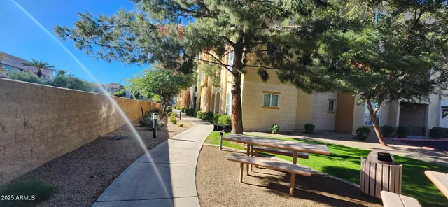 a backyard of a house with barbeque oven table and chairs