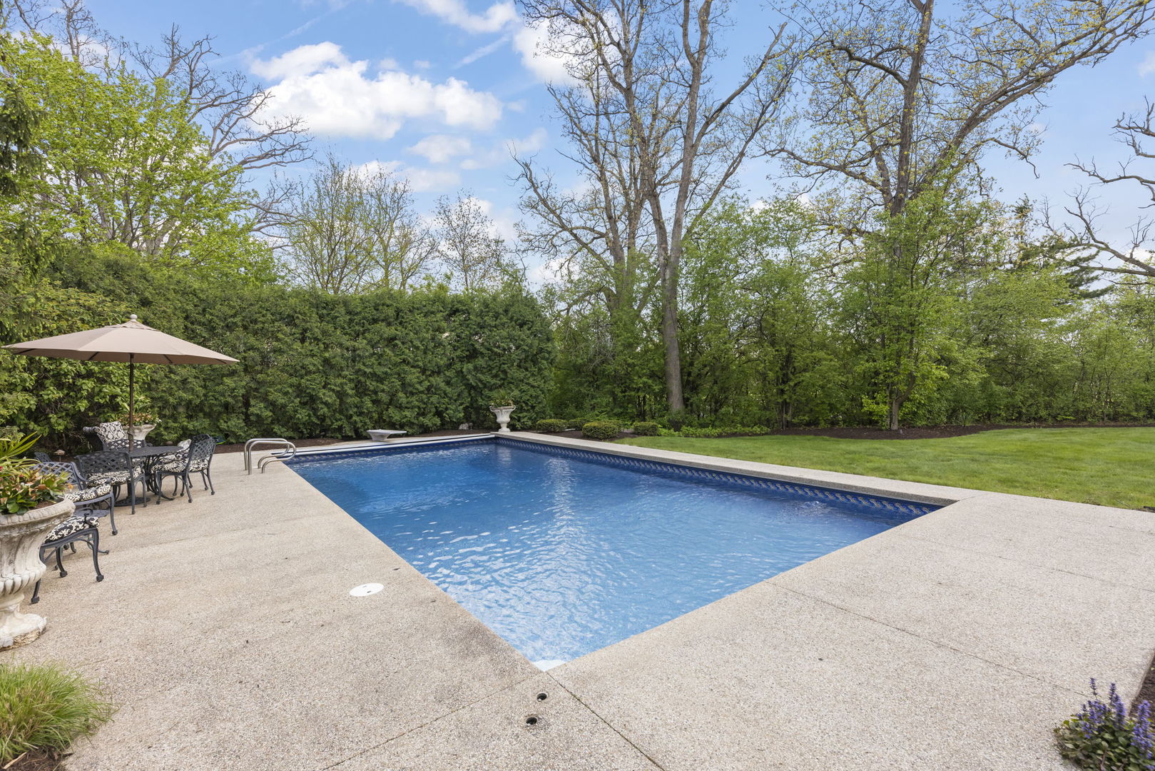 1S151 Winfield Road Wheaton, IL 60189 - Photo 60 of 73 a view of pool with lawn chairs under an umbrella