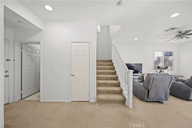a view of an empty room with stairs and ventilation
