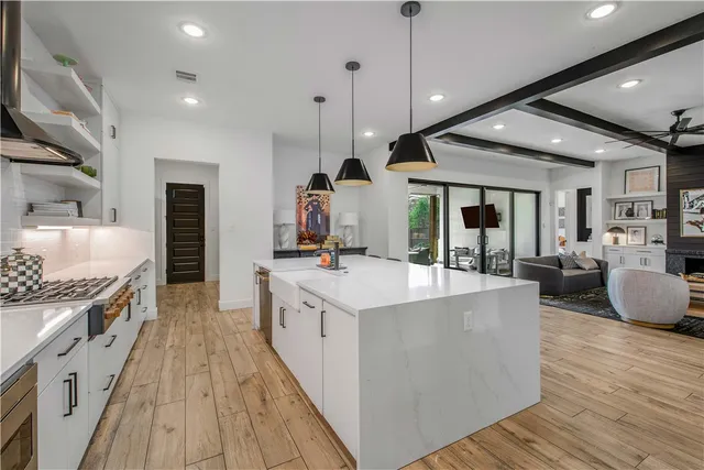 a large kitchen with stainless steel appliances lots of counter space