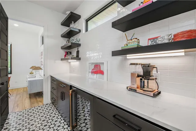 a large kitchen with stainless steel appliances granite countertop a lot of counter space and wooden floors