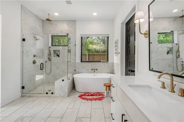 a bedroom with a large bed and a painting on the wall