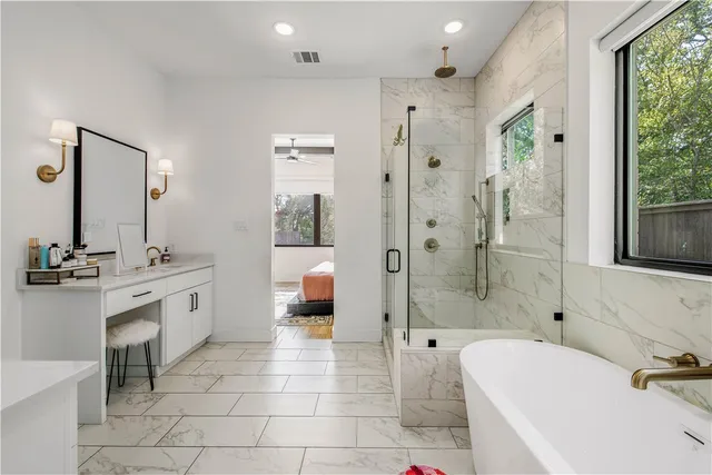 a bathroom with a tub sink and mirror