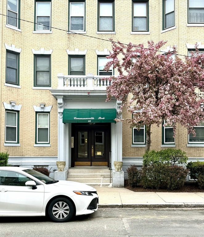 a car parked in front of a brick building