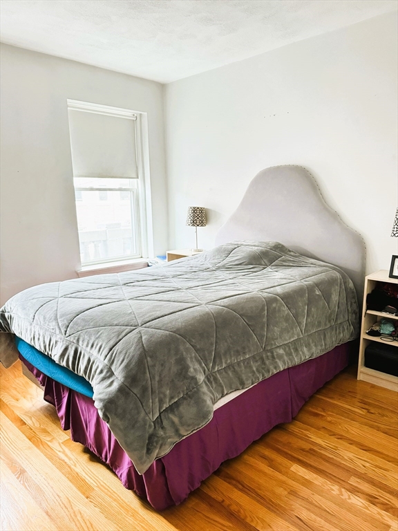 88 Gordon Street, Unit 306 Boston, MA 02135 - Photo 4 of 12 a bedroom with a bed and a window