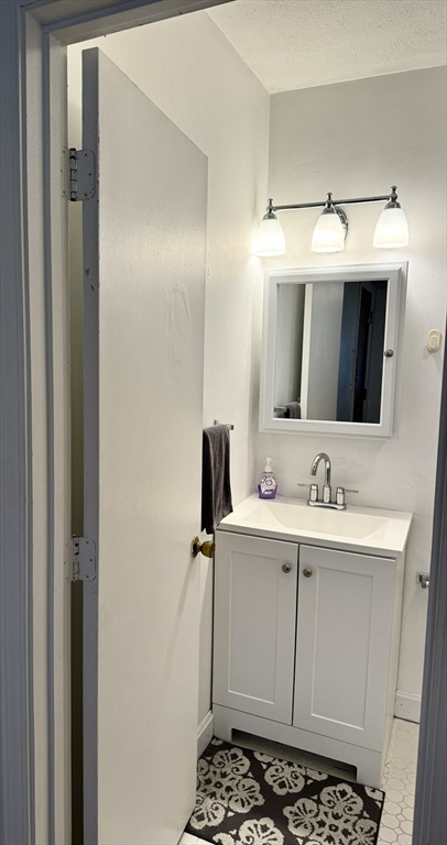 88 Gordon Street, Unit 306 Boston, MA 02135 - Photo 8 of 12 a bathroom with a sink and a mirror