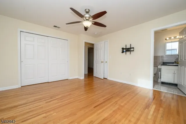 a view of a livingroom with a hardwood floor and a ceiling fan