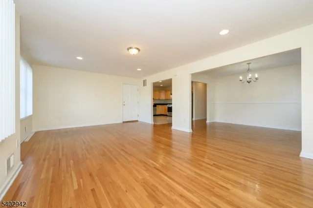 a view of empty room with wooden floor and cabinet