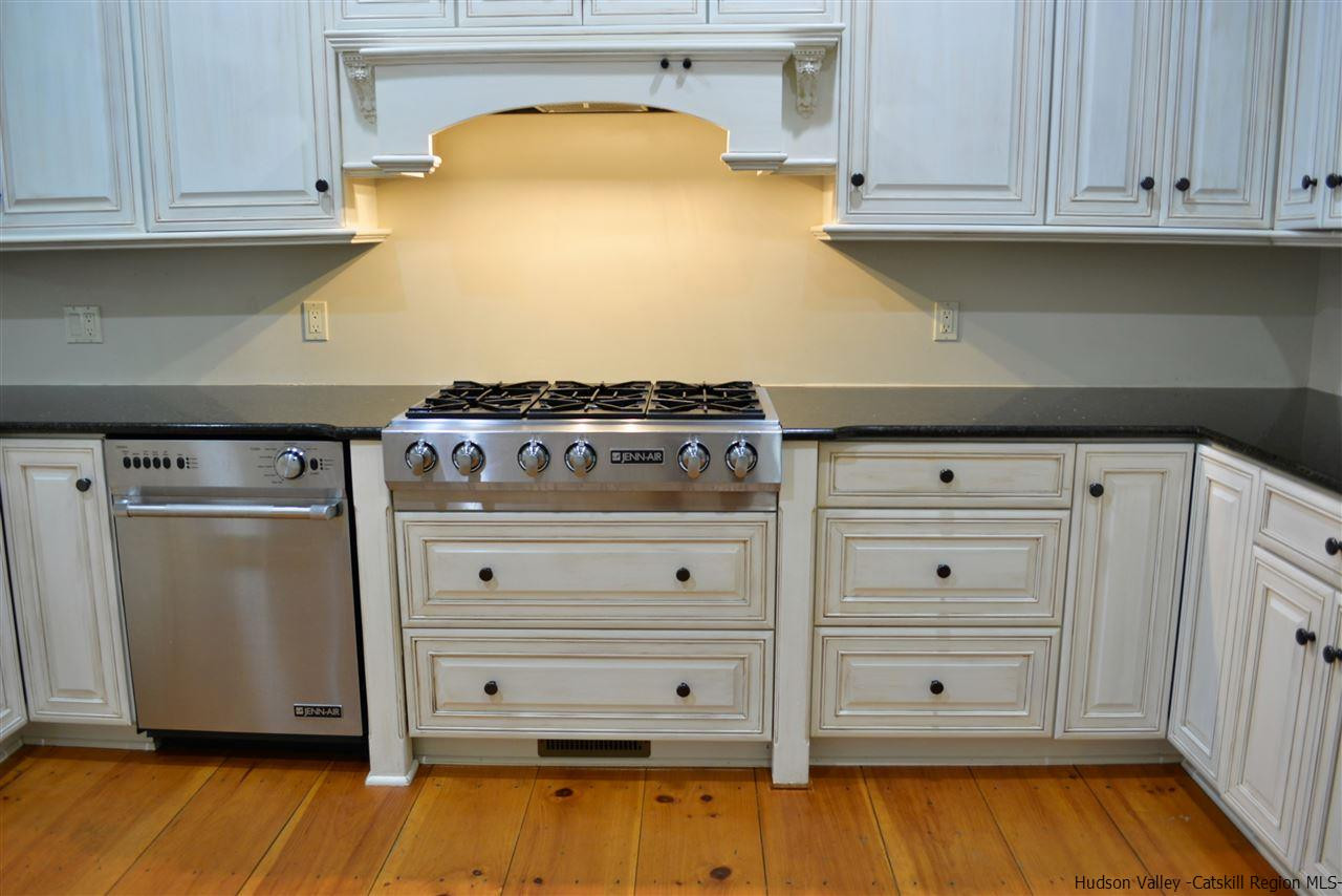 4651 Atwood Road Stone Ridge, NY 12484 - Photo 13 of 31 a kitchen with granite countertop white cabinets and white appliances