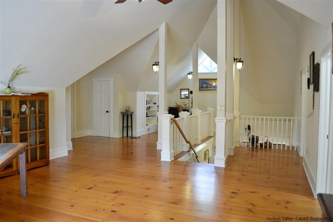 4651 Atwood Road Stone Ridge, NY 12484 - Photo 17 of 31 a view of a hallway with wooden floor and a living room